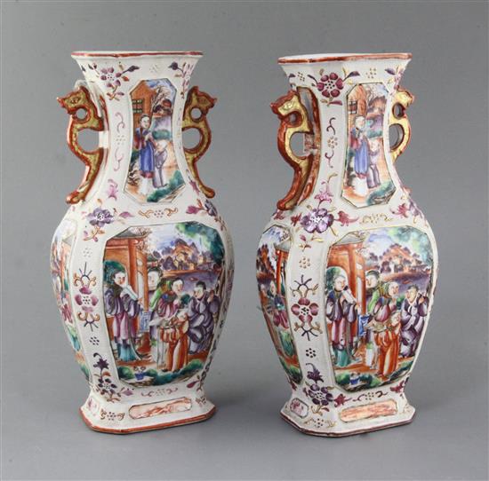 A pair of Chinese famille rose Mandarin hexagonal baluster vases, Qianlong period, height 27.5cm, slight damage